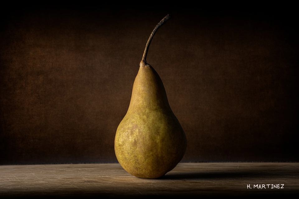 Desire: One pear, one light, and the quiet dignity of an ordinary object.